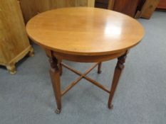 An early 20th century circular inlaid mahogany occasional table on paw feet