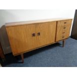 A mid 20th century six piece teak dining room suite comprising of sideboard,