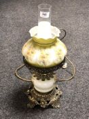 A brass and hand painted oil lamp with chimney and shade (converted)
