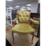 A French style salon armchair in gold buttoned dralon