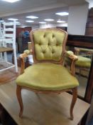 A French style salon armchair in gold buttoned dralon