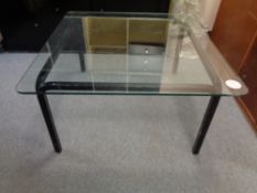 A square plate glass topped coffee table