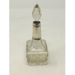 A silver-collared perfume bottle,