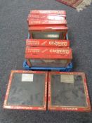 A basket of seven early 20th century Westons Biscuit tin counter top display cabinets