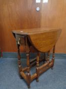 An Edwardian oak gate leg occasional table