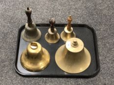 A tray of two brass ship's bells and two wooden handled bells