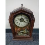 A late 19th century stained pine cased American mantel clock