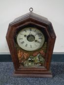 A late 19th century stained pine cased American mantel clock