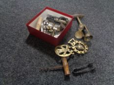 A box of horse brasses, bottle openers,