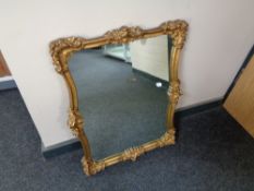 A 20th century gilt framed shaped wall mirror 56 cm x 68 cm