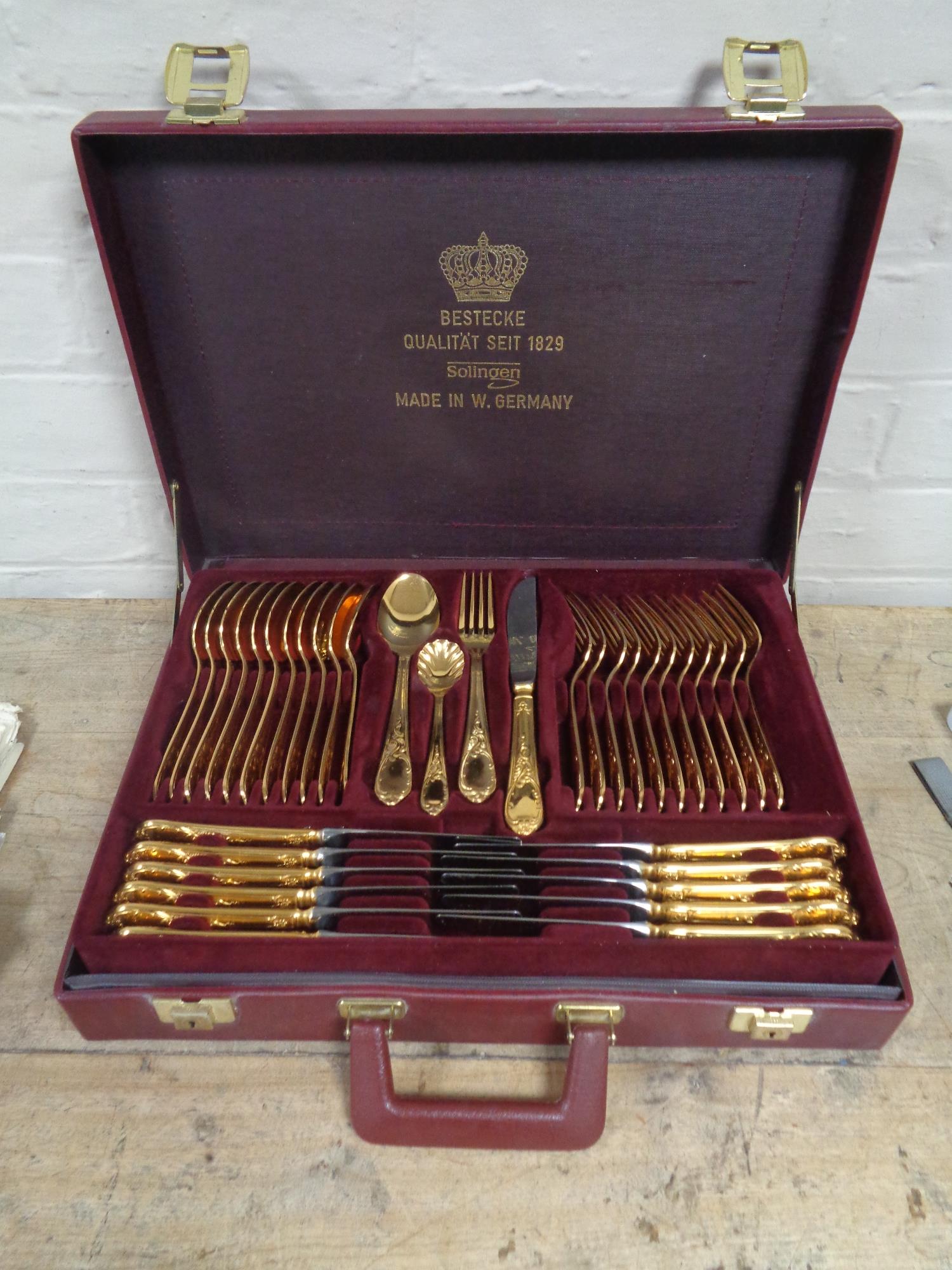 A set of West German Solingen gilded cutlery in fitted leather case
