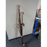 A bundle of 20th century walking sticks and crooks together with a shooting stick