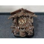 A Black Forest style cuckoo clock with pendulum and weights