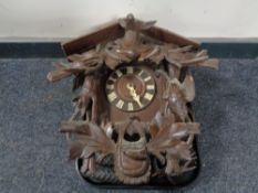 A Black Forest style cuckoo clock with pendulum and weights