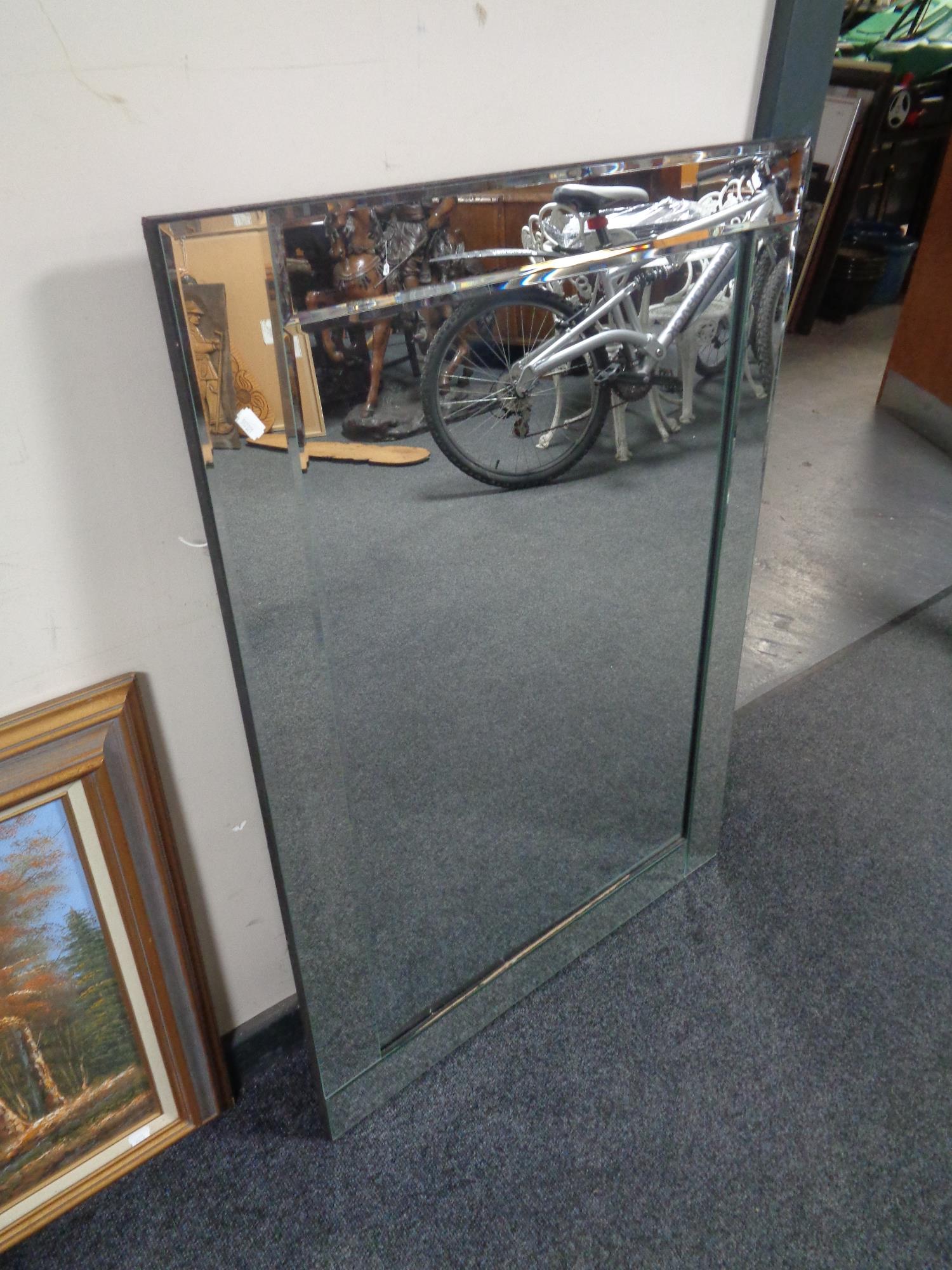An all glass frameless bevelled mirror
