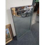 An all glass frameless bevelled mirror