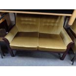 A late 20th century stained beech framed three piece suite upholstered in gold dralon