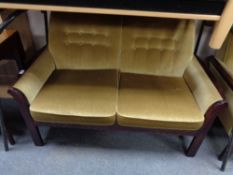 A late 20th century stained beech framed three piece suite upholstered in gold dralon