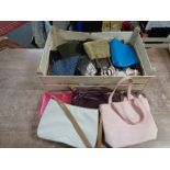 A crate of assorted lady's hand bags