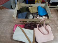 A crate of assorted lady's hand bags