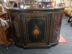 A Victorian ebonised, burr walnut and satinwood inlaid bowfront credenza with gilt metal mounts,