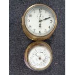 A circular brass maritime ship's clock and matching aneroid barometer