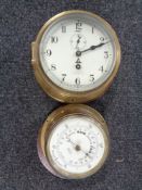 A circular brass maritime ship's clock and matching aneroid barometer