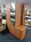 A teak effect combination wardrobe and bedside chest