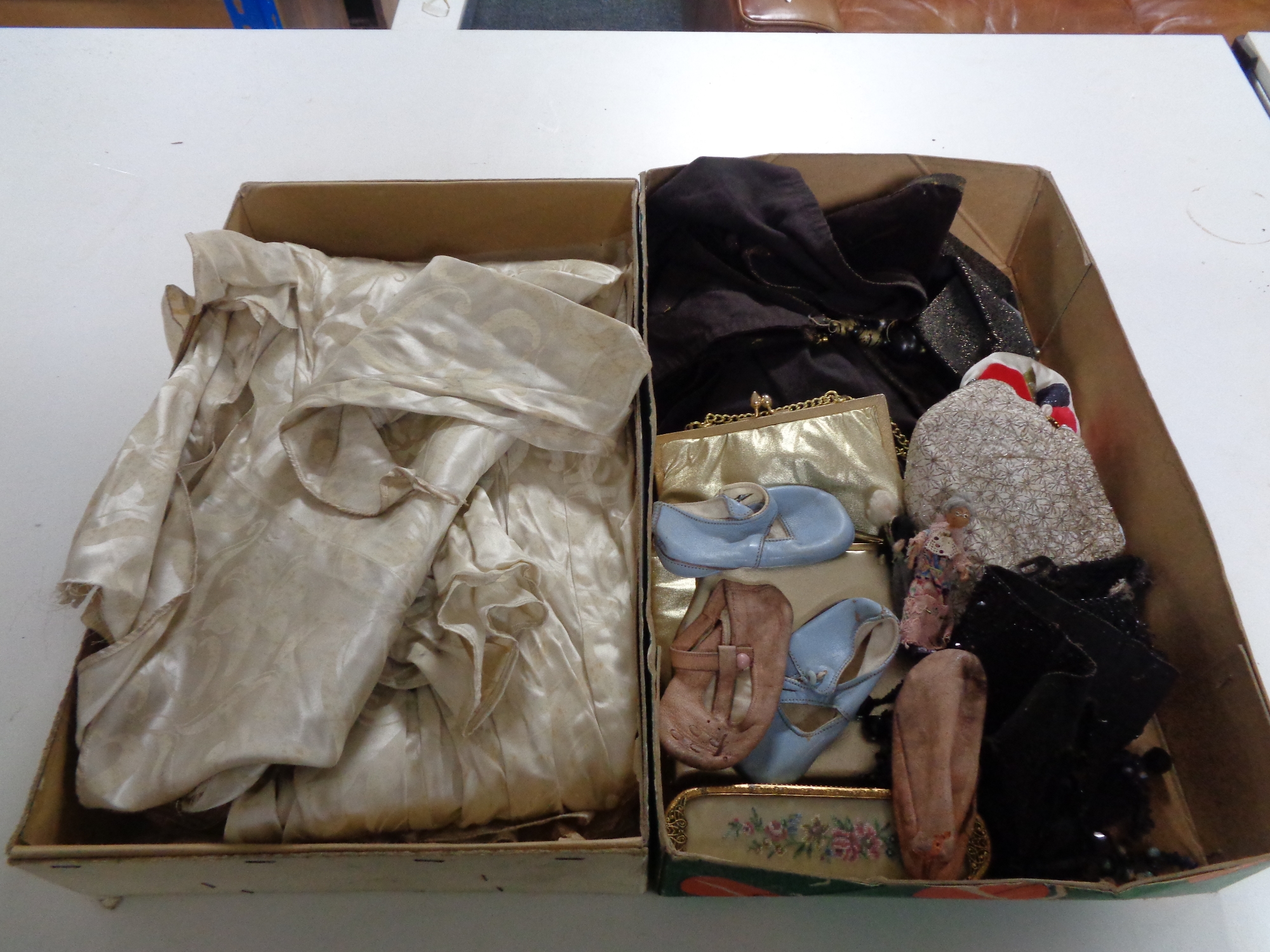Two boxes of vintage wedding dress, child's leather shoes,