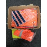 A box of new work clothes - florescent trousers and coats