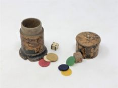 An antique treen box containing gaming counters and dice,