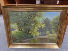 A 20th century gilt framed continental school oil on canvas, river through wooded landscape,