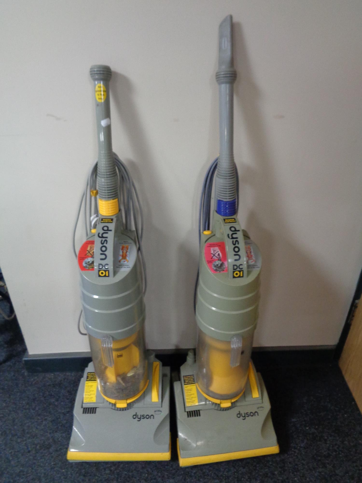 Two Dyson DC01 upright vacuums