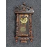 An early 20th century eight day wall clock with brass dial