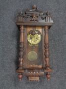 An early 20th century eight day wall clock with brass dial