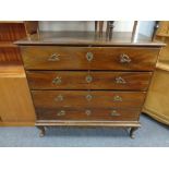 A 19th century four drawer chest on cabriole legs with brass handles and fittings