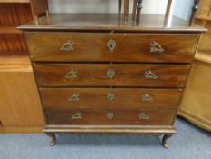 A 19th century four drawer chest on cabriole legs with brass handles and fittings