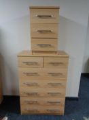 A pine effect seven drawer chest and matching bedside chest