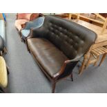 A 20th century mahogany framed shaped back settee upholstered in a black fabric , height 92 cm,