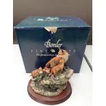 A Border Fine Arts figure of a fox with cubs on rock, on wooden stand,
