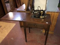 A vintage Jones electric sewing machine in table