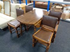 A stained beech drop leaf kitchen table and four Edwardian oak button leather chairs