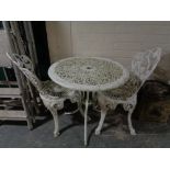 A painted cast metal patio set comprising of circular pedestal table and two chairs