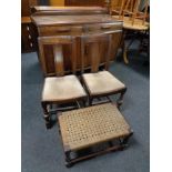 A pair of Edwardian oak dining chairs and a stained pine rush seated stool