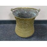 An antique brass Eastern embossed bucket