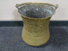 An antique brass Eastern embossed bucket