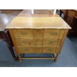 A 20th century oak serpentine front three drawer chest