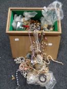 A plywood box of a large quantity of costume jewellery to include beaded necklaces, bracelets,