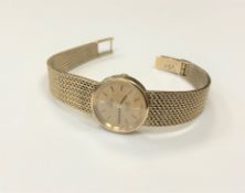 A lady's 9ct gold Omega De Ville quartz wristwatch on 9ct gold integral bracelet (lacks crown)