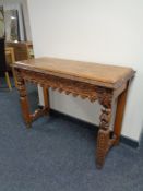 An Edwardian carved oak console table